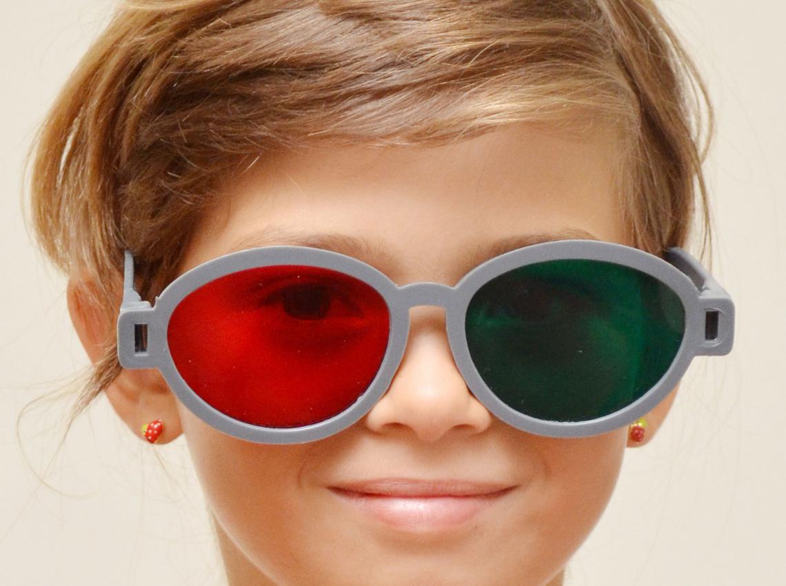 girl wearing red green glasses for vision therapy